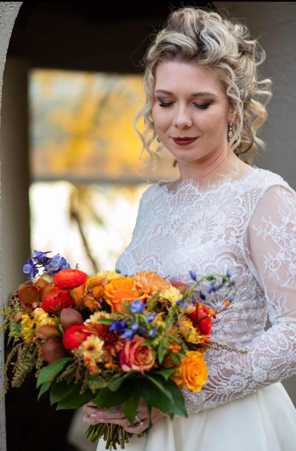 Half Bridal Updo to highlight dramatic makeup for a fall wedding